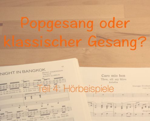 Hörbeispiele zu Popgesang und klassischem Gesang. Noten zu einer klassischen Arie und einem Popsong auf einem Tisch.