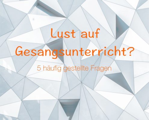 Häufig gestellte Fragen über Gesangsunterricht Das Foto zeigt eine Wand, die mit grauen Dreiecken verziert ist.